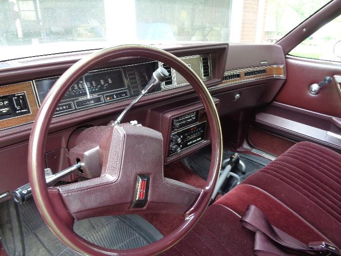 Interior is maroon and in Excellent condition