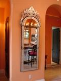 19th century Venetian mirror is larger than most.