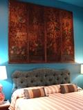 Hand painted leather screen used as an art accent in guest room. Bed is for sale. Custom bedding throughout the house is by international designer Carlton Varney
