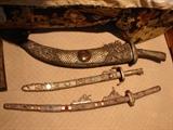 Ceremonial swords are shown on the floor. They are large size.