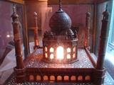Impressive lighted model of the Taj Mahal with extensive inlay work. In glass display case.
