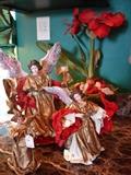 Three of a large collection of papier mache angels. There is a large selection of garland and outdoor holiday decorations as well as indoor