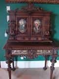 Ornately carved small desk with hand painted accents.