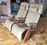 Two Interactive Health "Perfect Chair" Model PC-095 chairs, made in 2007. The leather upholstery and electric mechanism that positions the chair in numerous positions from upright to fully reclined are in excellent condition.