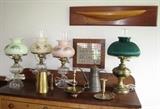 Electrified antique kerosene lamps, half model of a boat, and brass and tin country smalls