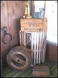 Primitives, ice tongs, wooden carved telephone lamp, lobster cage, cake or chocolate mold form, wooden box from Hutchinson Produce Co. 