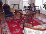 Room-sized vintage wool Oriental rug, Victorian table with glass ball and claw feet