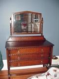 Three drawer dresser with mirror held by barley twist frame
