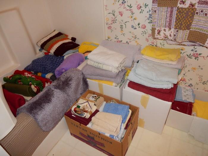 boxes of towels, blankets, and linens