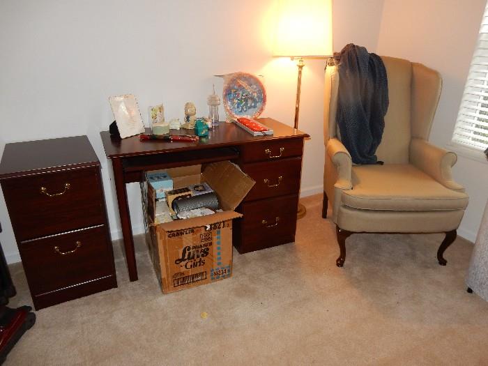 desk, matching file cabinet, empty precious moment boxes and a lovely wing chair