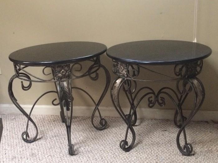 a pair of iron and faux stone top coffee tables