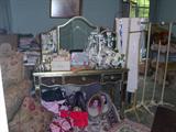 Mirrored dressing table, vintage clothing racks, designer purses, crystal chandelier