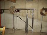 Several clothes racks are in the basement; the chrome rack in the middle is a "must have",