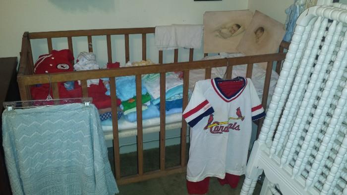 Vintage crib with mattress, baby clothing & linens. 