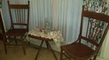 Antique spindled back chairs with leather bottoms (set of 4 available). Crystal/cut glass, doileys, tri-pod wooden table. Antique flip glasses. 