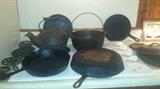 Cast iron collection including skillets, kettles, trivets, and more! Small advertising iron. 