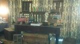 Primitive general store table (in AS IS condition), crates, 2 of 6 Brumby chairs (Marietta, GA), Coca Cola & Pepsi collectibles. 
