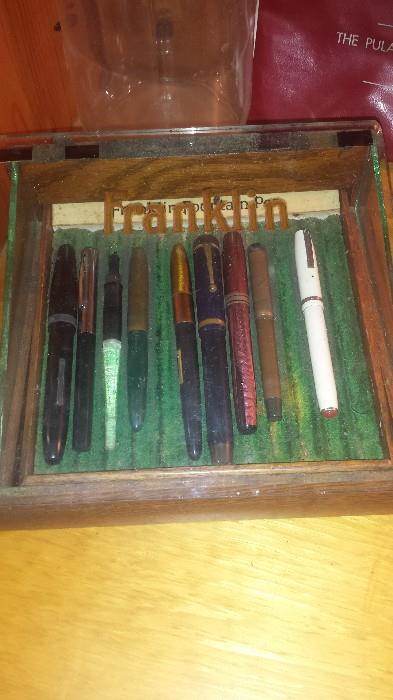 Franklin fountain pen advertising display. Several fountain pens including Parker, Franklin, Wearever Hundred Year pen, and more. 