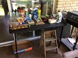 Patio area - cleaning supplies, grill, 2 chairs, old wooden step stool