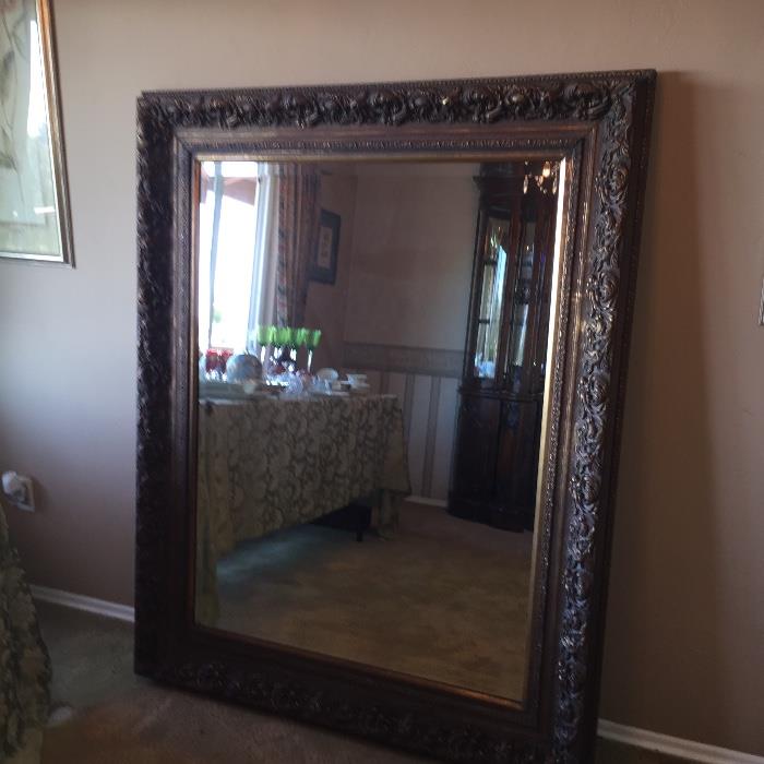 Very large vintage beveled mirror with ornate frame.