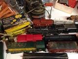 American Flyer locomotive #316 Pennsylvania Rail Road in black and #355 Chicago Northwestern & Baldwin in green and yellow. Include log cars with logs and rocket launchers, search lights, etc...