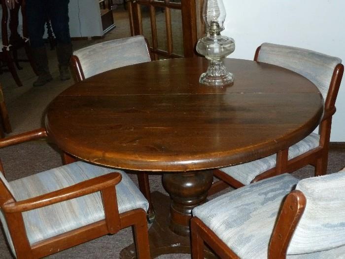 Solid wood pedestal table and four chairs on casters