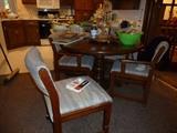 Round pedestal table with leaf and four chairs on casters