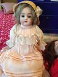 Antique porcelain doll with steamer trunk full of clothing
