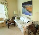 Lovely floral sofa, ccent tables, swivel lounge chair, original art