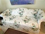 Camelback white floral upholstered sofa
