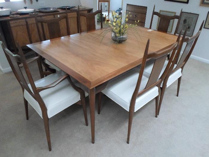 Mid-century modern dining table with 2 additional leaves and 6 fabulous chairs in white vinyl.  Beacon Hill collection by Kaplan.  Like new condition.