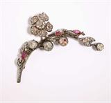 Lot# 1005 An antique diamond and ruby flower brooch 









Circa 1850, silver-topped yellow gold, the top flower set with 1 old-mine-cut diamond gauged at approximately 8.5 x 7.8 x 3.7mm and gauged at approximately 1.60 cts, graded K-L color and SI clarity, detachable to be worn as a separate brooch, the main brooch further set with three large backed rose-cut diamonds measuring 7.3 - 8 mm, and 1 backed rose-cut diamond measuring 6 x 7 mm, further enhanced by 85 rose and old mine-cut diamonds totaling approximately 1.50 cts, and three pear-shaped rubies (with additional brooch fitments), 23 gms, 3.5'' x 1.50''. est:$8000/12,000
