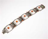Lot# 1033 A carnelian, marcasite and silver bracelet, Theodore Fahrner 









Circa 1930, signed Theodore Fahrner, with five rectangular panels of frosted rock crystal each centering a round cabochon orange carnelian with black enamel, marcasite and carnelian arched spacers, 7.25''. est:$600/800