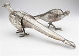Lot# 1043 A pair of Continental sterling silver pheasant-form table ornaments 









20th century, each marked ''Sterling'' to underside of tail feather, each apparently lacking maker's mark, each realistically modeled, one as a cock the other as a hen, with hinged wings, 2 pcs, 27 oz troy tw approximately, the larger. 7'' H x 18.25'' W x 3'' D. est:$1000/1500