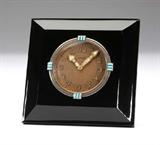 Lot# 1041 An Art Deco amethyst-glass desk clock, Cartier 









Circa 1930, the dial signed ''Cartier'', the stand signed ''European Watch & Clock Co Inc. France'' and ''1801'', with mechanical movement, the engine-turned dial with Arabic numeral markers and luminescent hands within a smooth bezel decorated at intervals with turquoise-colored enamel, enclosed in a square beveled dark amethyst-colored glass case, mounted on a gilt metal folding stand. 3.5'' H x 3.5'' W x 0.5'' D. est:$2000/3000