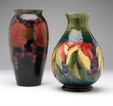 Lot# 1052 Two Moorcroft vases 









Circa 1920's, the first: blue ground decorated with pomegranates, impressed ''Moorcroft'' and signed in green; the second: green ground decorated with grapes and leaves, signed twice in blue, impressed ''Made in England'' and ''Potter to HM the Queen''; the first. 10'' H x 5'' Dia. est:$500/800