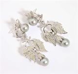 Lot# 1063 A pair of gray cultured pearl, diamond and 18K white gold pendant earrings 









The cultured pearls measuring approximately 10.20 mm, set with 158 full-cut diamonds totaling approximately 2.80 cts, graded J-K-L-M color range and SI-I clarity, 2.5''. est:$1200/1800