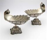 Lot# 1071 A pair of German .800 silver sweetmeat dishes, Bruckmann and Sohne, Heilbronn 









Early 20th century, each with maker's mark and ''800'', each also with retailer's mark ''Posen'', each modeled as a shell with scrolled acanthus handle, on a C-scroll and palmette-decorated quadripartite foot, 2 pcs, 25.8 oz troy tw approximately, each. 8'' H x 9.5'' W x 6.5'' D. est:$1200/1800