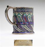 Lot# 1078 A Russian 88-standard silver and enamel cup 









1893, Moscow, with maker's mark ''AK'' (possibly Antip Kuzmichov) and assayers mark ''AA'' (possibly Anatoly Artsibashov), further marked ''Made for Tiffany & Co.'' and inscribed to underside ''Ruth Hamilton Hoyt / from Grandma & Grandpa Hoyt / Xmas 1896'', the cylindrical body with raised spiral waves decorated with leaves, flowers and bands in cobalt, turquoise, azure, white, black and red enamel, with a Cyrillic inscription. 3.25'' H x 2.75'' D, 7.2 oz troy approximately. est:$800/1200
