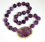 Lot# 1156 A finely carved amethyst bead, diamond and 18K yellow gold necklace 









The four tested 18K yellow gold and diamond roundels attached to an oval iris-motif carved amethyst with a tested 14K yellow gold and diamond accent front bezel clasp, set with 58 full-cut diamonds totaling approximately 0.70 ct, graded H-I color and SI clarity, 16''. est:$1500/2000