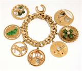 Lot# 1101 A 14K yellow gold charm bracelet 









Suspending 8 stone and gold large charms, 8'', 133.5 gms. est:$3000/4000
