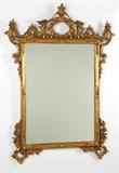 Lot# 1115 An Italian carved gilt wood wall mirror 









First half 20th century, the rectangular plate within a carved and pierced surround of C-scrolls, flowers and foliage. 56.25'' H x 40.25'' W x 2'' D. est:$1200/1800