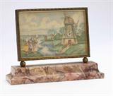 Lot# 1120 A Swiss vanity clock, Lebeau Moulin 









Probably 1920s, signed to back ''Lebeau Moulin / fab Suisse'' and marked ''72864'', mechanical movement, the minute dial affixed to a hand painted Dutch genre scene within a gilt metal frame, mounted on a pink marble stepped rectangular base. 4'' H x 5.25'' W x 1.5'' D. est:$700/900