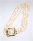 Lot# 1132 A triple strand of cultured pearls with a mabe pearl, diamond and 14K gold clasp 









The square clasp set with 12 full-cut diamonds totaling approximately 0.40 ct, graded H-I color and SI-I clarity. Cultured pearls measure 7.50 - 7.00mm, 17.25''. est:$600/800