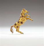 Lot# 1160 A ruby, diamond, enamel and 18K yellow gold rearing horse brooch, Tiffany & Co 









Signed Tiffany & Co, with yellow enamel and ruby eyes and markings, set with 36 single-cut diamonds as the mane and tail totaling approximately 0.45 ct, graded G-H color and VS clarity, 30.3 gms. est:$4000/6000