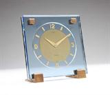 Lot# 1188 An 8-Day desk clock, Cartier 









Mid 20th century, the dial signed Cartier and marked ''8-Days'' and ''Swiss'', mechanical movement, the circular dial with Arabic numeral and stick markers, within a square blue glass case with brass studs, on two brass feet. 4.75'' H x 4.75'' W x 2.25'' D. est:$500/700
