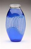 Lot# 1185 A cobalt and clear glass vase, Archimede Seguso for Tiffany & Co 









1990, engraved to base ''Archimede Seguso 1990 / 2/7 / Tiffany & Co.'', ovoid form with flared neck, cobalt blue with free-form cobalt, white and clear lattice band, clear neck and cobalt lip. 12.75'' H x 7'' W x 5.5'' D. est:$600/900