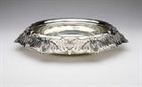 Lot# 1199 A sterling silver pierced center bowl, Graff, Washbourne & Dunn 









First quarter 20th century, with makers mark, further marked ''Sterling / 161/2 in'' and ''2912 / 46'' and ''Patented / 5/18 1909'', the wide everted rim chased and pierced with floral, C-scroll, trellis and laurel swag decoration, on a circular foot. 3.25'' H x 16.5'' Dia., 53.1 oz troy approximately. est:$1000/2000