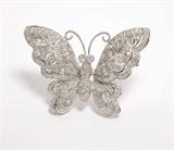 Lot# 1059 A diamond and 18K white gold butterfly brooch 









Set with 122 full-cut diamonds totaling approximately 1.15 cts, graded I-J color and SI clarity, 15.1 gms. est:$800/1200