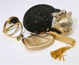 Lot# 1067 A Judith Leiber black and white crystal 'Sleeping Cat' minaudiere evening clutch		

Marked ''Judith Leiber'', the curled up cat with bow collar, with snap closure, comb, mirror and coin purse, 4 pcs. 3'' H x 6'' W x 4'' D. est:$800/1200